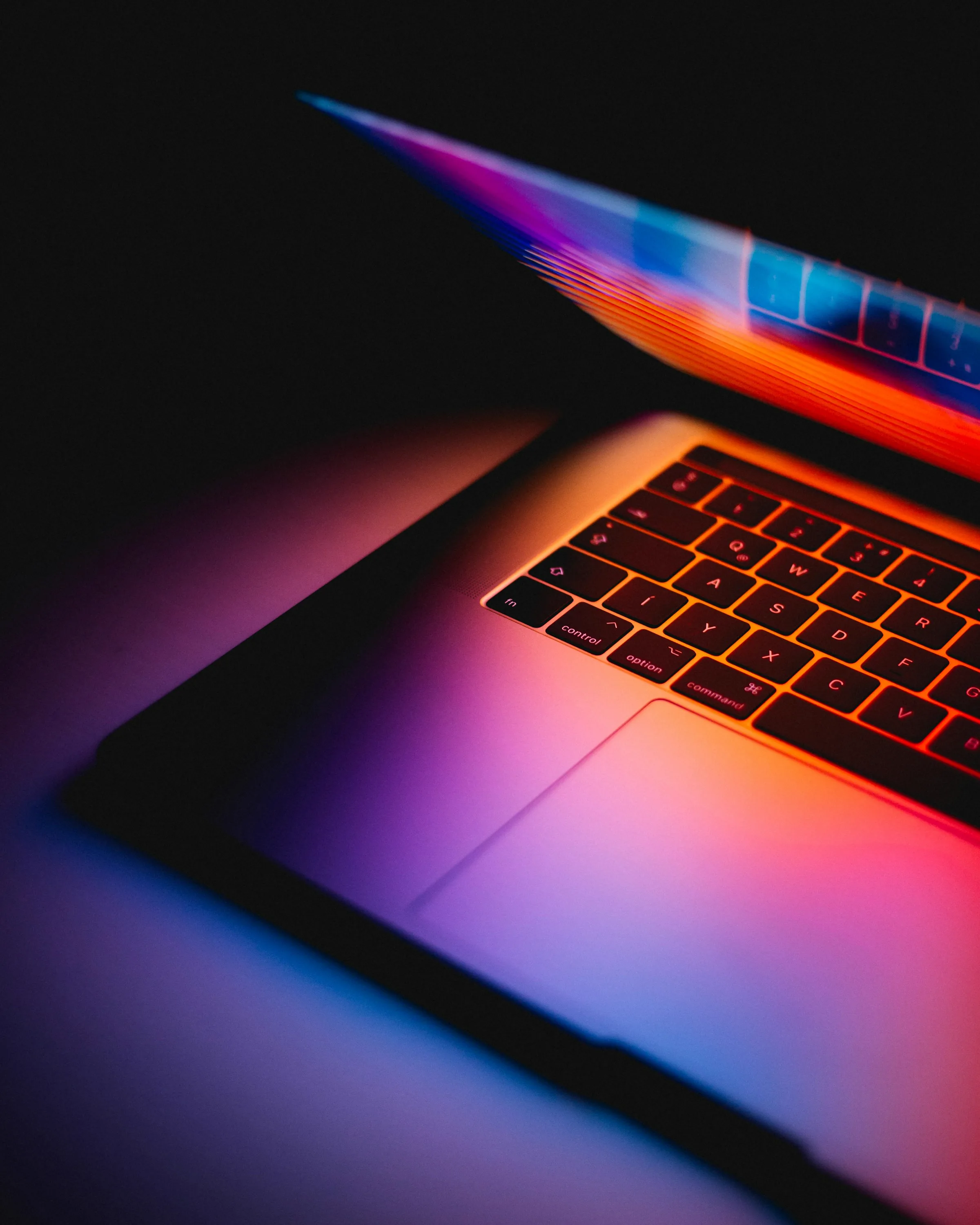 Laptop under neon light during a QA session